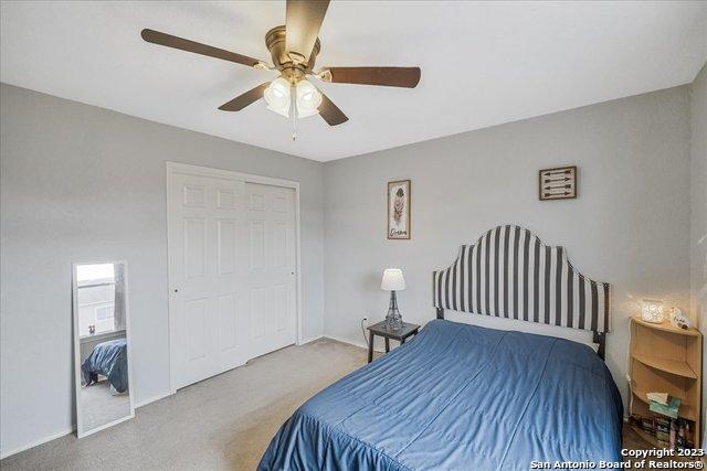 bedroom featuring ceiling fan, a closet, and carpet