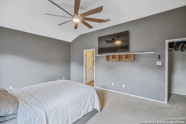 carpeted bedroom featuring ceiling fan and vaulted ceiling