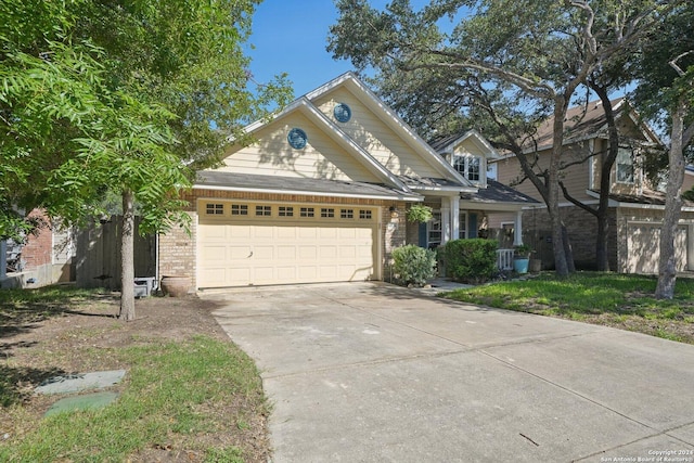 view of front of house featuring a garage, brick siding, and driveway