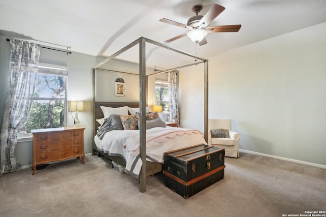 carpeted bedroom featuring baseboards and a ceiling fan