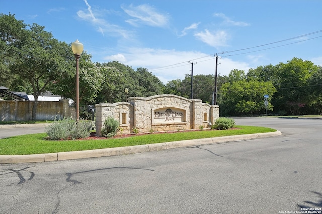 community sign featuring fence