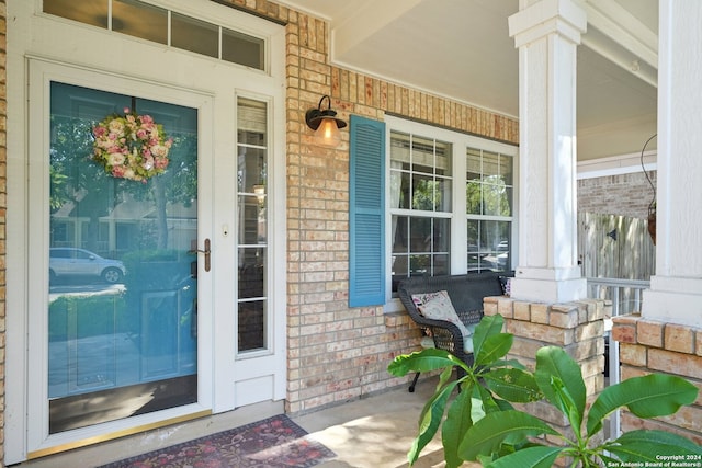 property entrance featuring brick siding