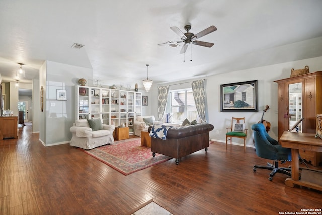 living area with dark wood-style floors, baseboards, visible vents, and ceiling fan