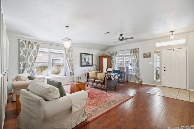 living room featuring baseboards, visible vents, a ceiling fan, wood finished floors, and vaulted ceiling