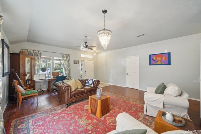 living area with dark wood-type flooring, visible vents, vaulted ceiling, and an inviting chandelier