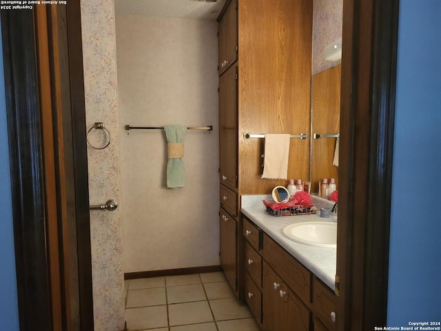 bathroom featuring a textured ceiling, vanity, and tile patterned floors