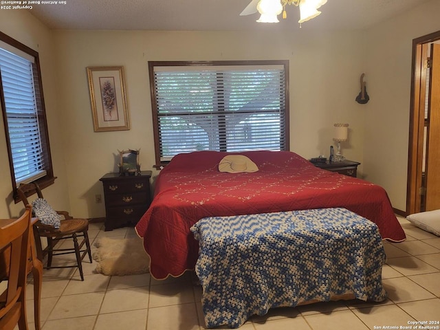 tiled bedroom with ceiling fan