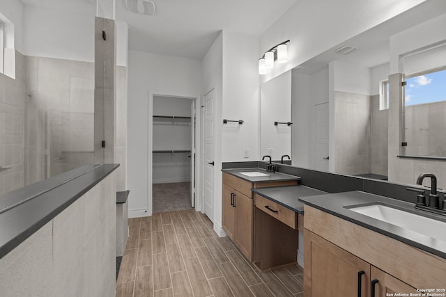 bathroom featuring vanity and a tile shower