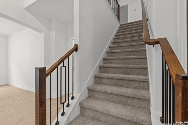 staircase featuring wood-type flooring