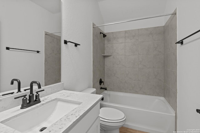 full bathroom with vanity, toilet, and tiled shower / bath combo