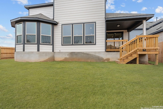 rear view of house featuring a yard