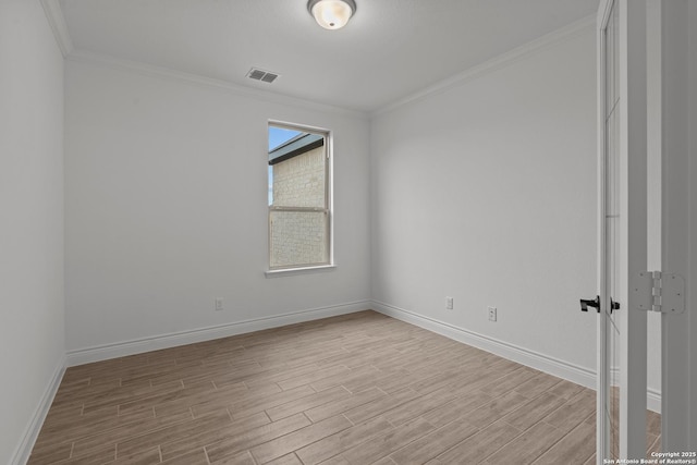 unfurnished room with crown molding