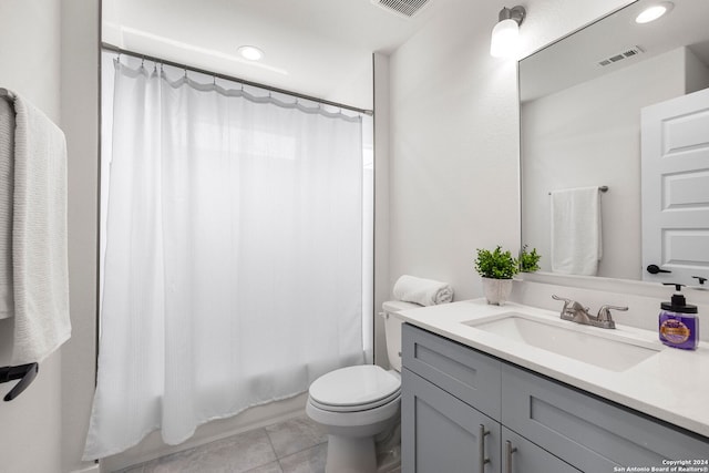 full bathroom featuring shower / bath combo with shower curtain, tile patterned flooring, toilet, and vanity