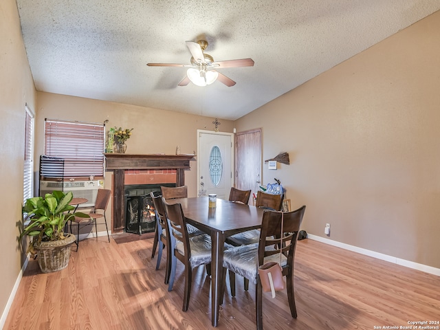 dining area with a textured ceiling, light hardwood / wood-style flooring, and ceiling fan