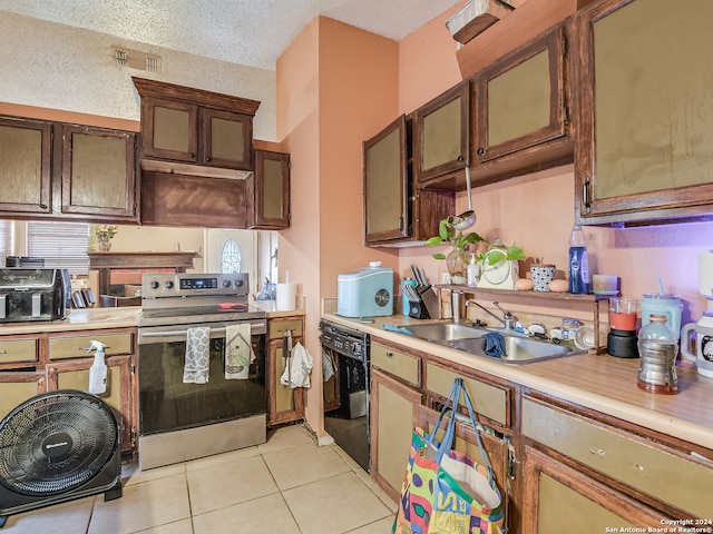 kitchen with light tile patterned floors, a textured ceiling, stainless steel electric stove, dishwasher, and sink