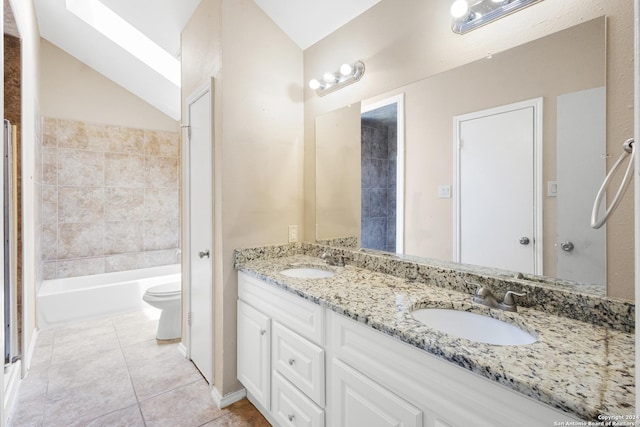 full bathroom featuring tile patterned flooring, vanity, vaulted ceiling, toilet, and tiled shower / bath