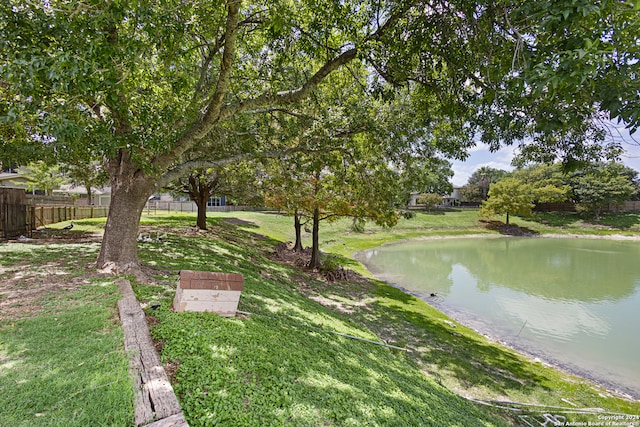 exterior space with a water view and a lawn