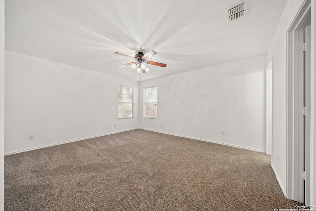 empty room featuring carpet floors and ceiling fan