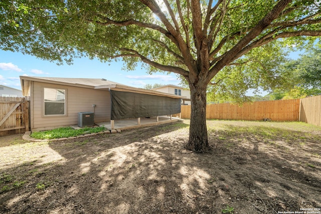 view of yard with cooling unit and a patio area