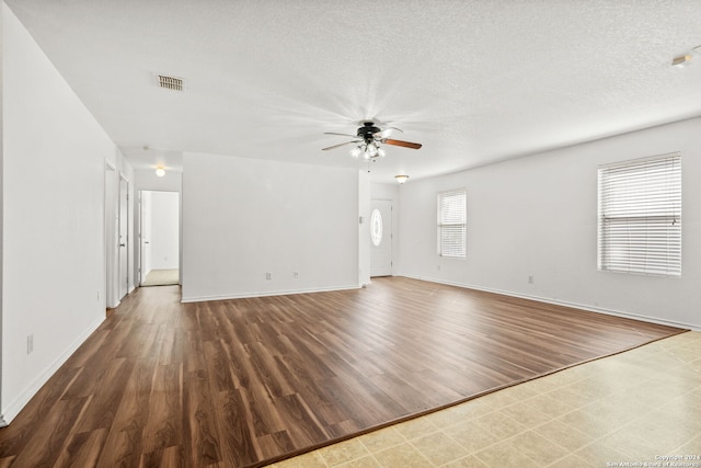 unfurnished room featuring dark hardwood / wood-style floors, a textured ceiling, and ceiling fan