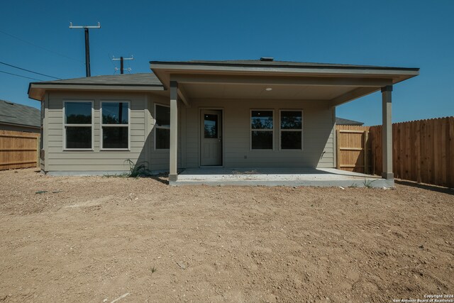 back of property with a patio