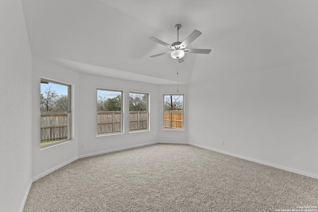 carpeted spare room with ceiling fan and lofted ceiling