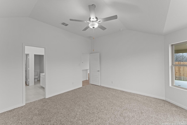 unfurnished bedroom with ceiling fan, ensuite bathroom, lofted ceiling, and light colored carpet