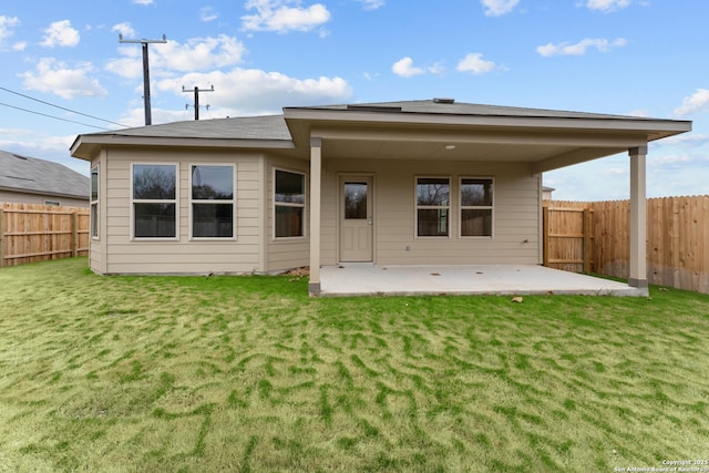 rear view of property with a lawn and a patio