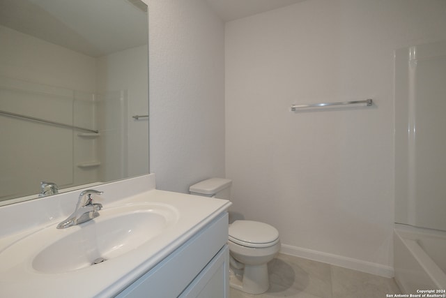 bathroom featuring toilet, vanity, tile patterned flooring, and a shower