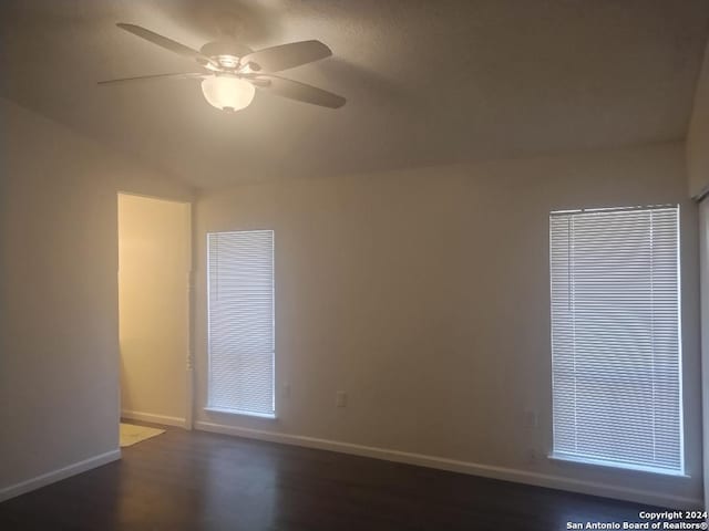 unfurnished room with ceiling fan, dark wood-type flooring, and vaulted ceiling