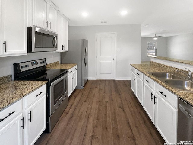 kitchen with white cabinetry, sink, stainless steel appliances, and stone counters