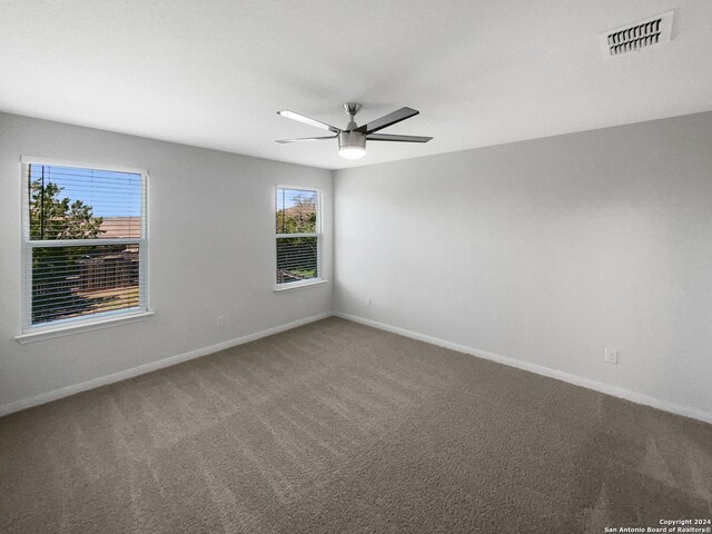 carpeted empty room with ceiling fan