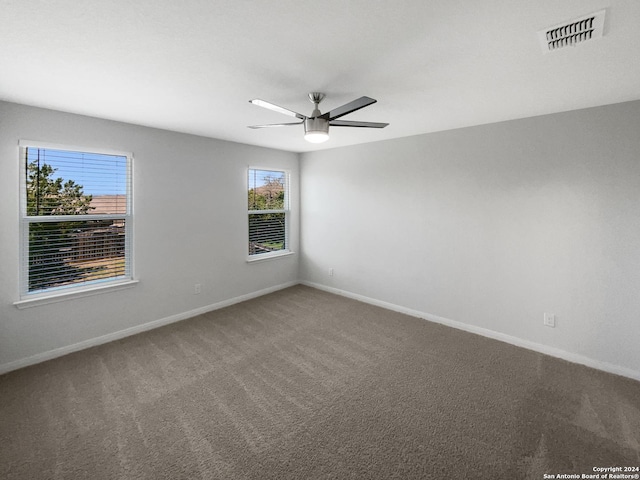 empty room with carpet floors and ceiling fan