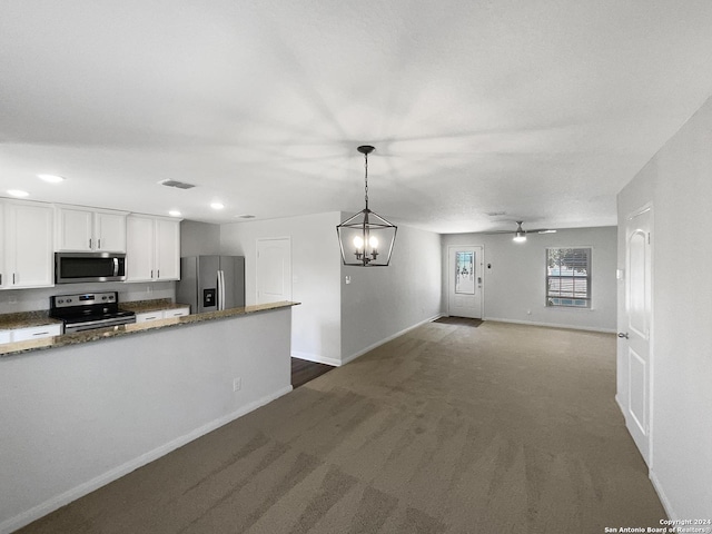 kitchen with dark colored carpet, white cabinetry, hanging light fixtures, ceiling fan, and stainless steel appliances