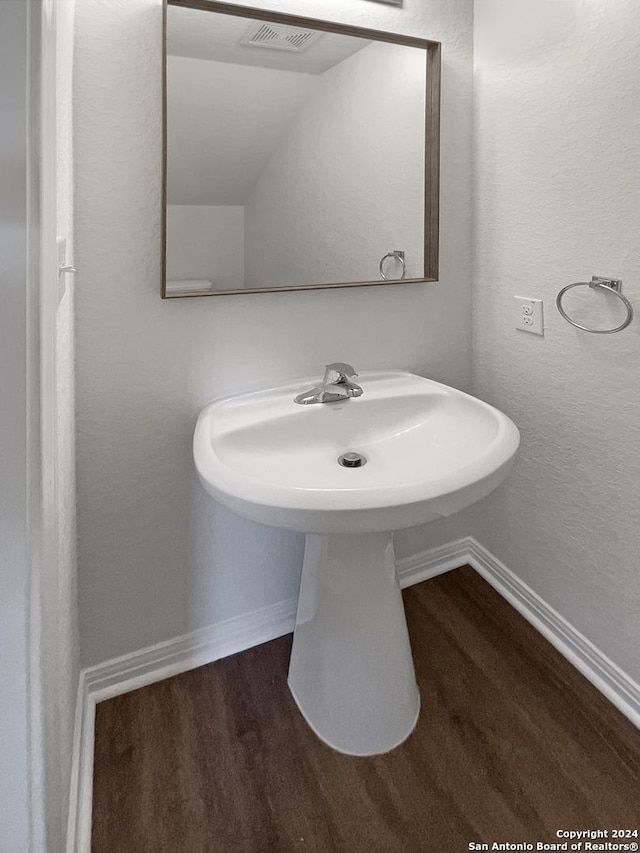 bathroom with wood-type flooring and sink