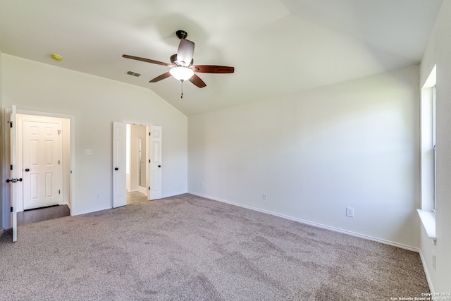 unfurnished bedroom with ceiling fan, lofted ceiling, and carpet flooring