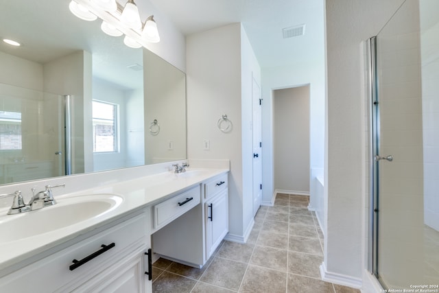 bathroom featuring double vanity, separate shower and tub, and tile patterned floors