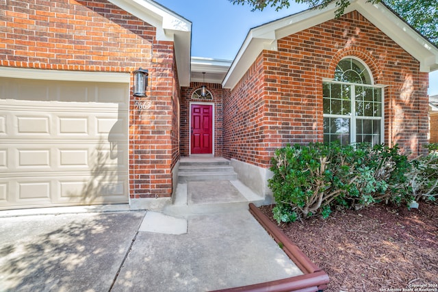 view of exterior entry with a garage