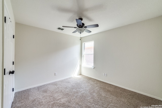 empty room featuring carpet floors and ceiling fan