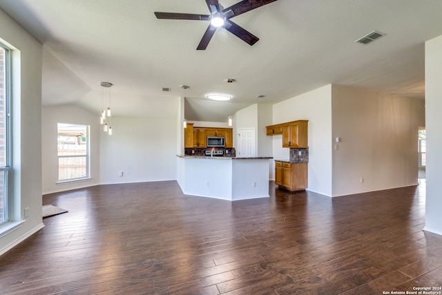 unfurnished living room featuring dark wood-type flooring, ceiling fan, and lofted ceiling