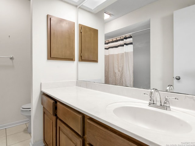 bathroom featuring vanity, tile patterned flooring, and toilet