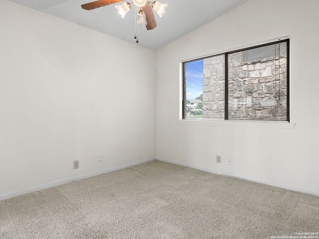 carpeted spare room with lofted ceiling and ceiling fan