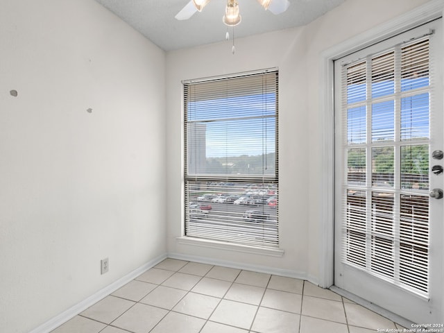 unfurnished room featuring light tile patterned floors and ceiling fan