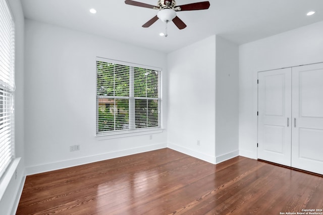 unfurnished bedroom with a closet, ceiling fan, and dark hardwood / wood-style floors