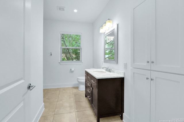 bathroom featuring vanity, toilet, and tile patterned flooring