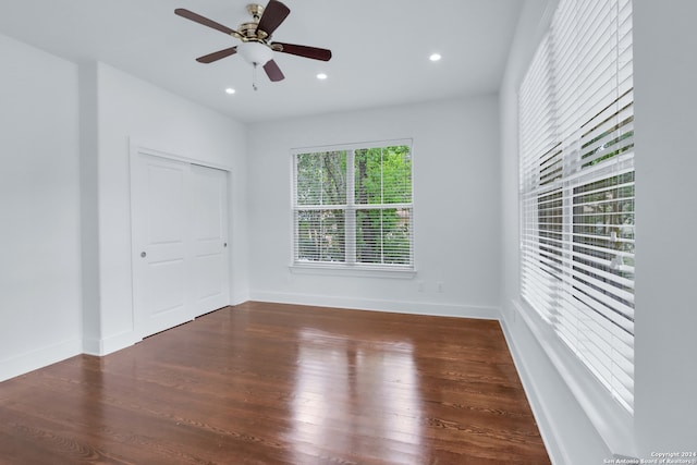 spare room featuring dark wood-type flooring and ceiling fan