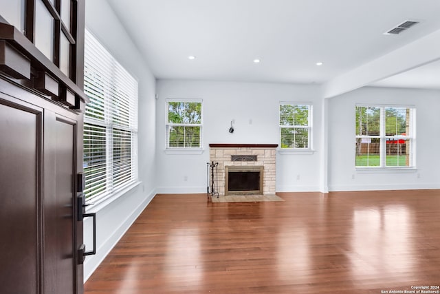 unfurnished living room featuring a fireplace and wood-type flooring