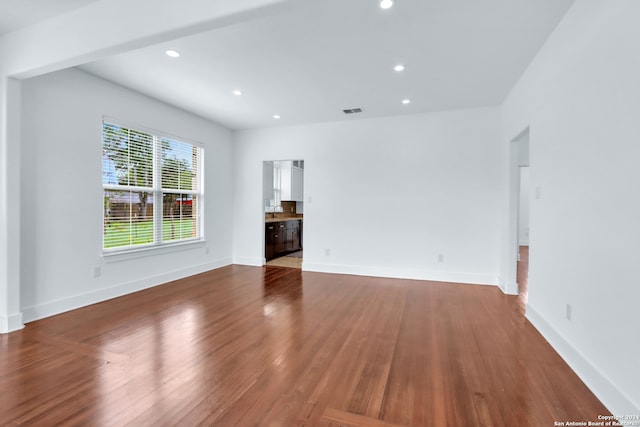 unfurnished living room featuring wood-type flooring