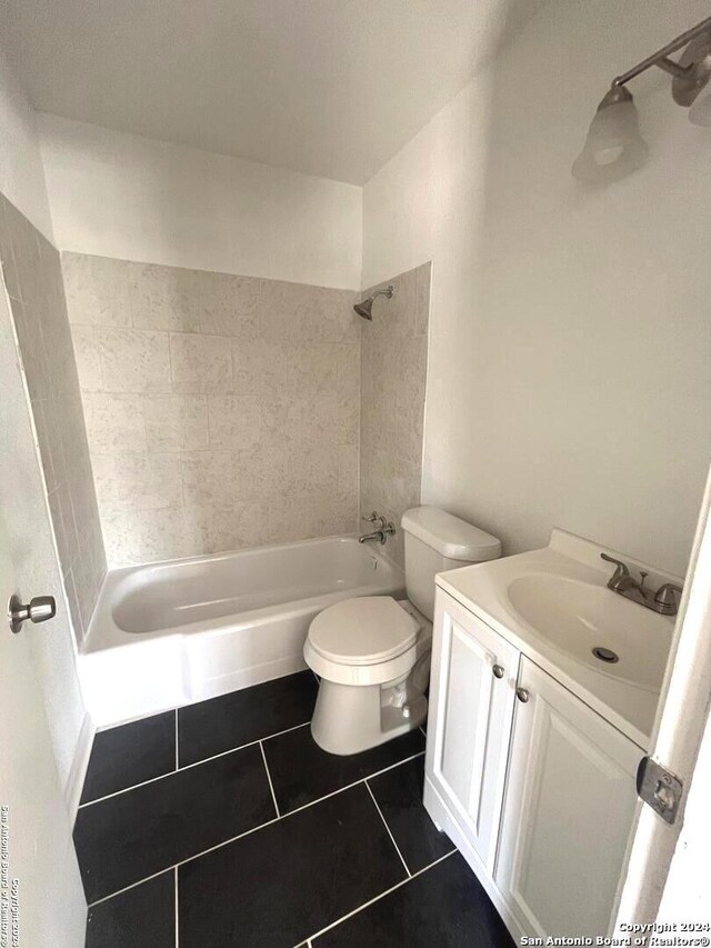 full bathroom with vanity, tiled shower / bath combo, toilet, and tile patterned floors