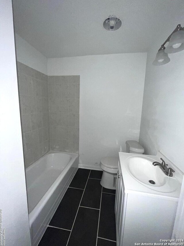 full bathroom featuring vanity, tiled shower / bath combo, toilet, and tile patterned floors